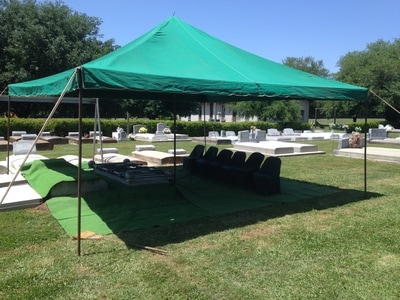 Graveside set-up complete — tent and chairs at burial site